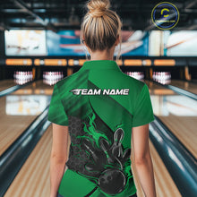 Load image into Gallery viewer, Female model at a bowling lane, back view of black and green quarter zip shirt showcasing flame bowling ball hitting pins with geometric hexagon pattern