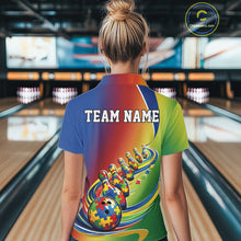 Load image into Gallery viewer, Female model at a bowling alley, back view of colorful polo shirt featuring autism puzzle bowling ball trailing matching bowling pins