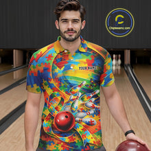Load image into Gallery viewer, Male model in a bowling lane wearing a colorful polo shirt, front view featuring autism ribbon and puzzle bowling artwork with bright accents
