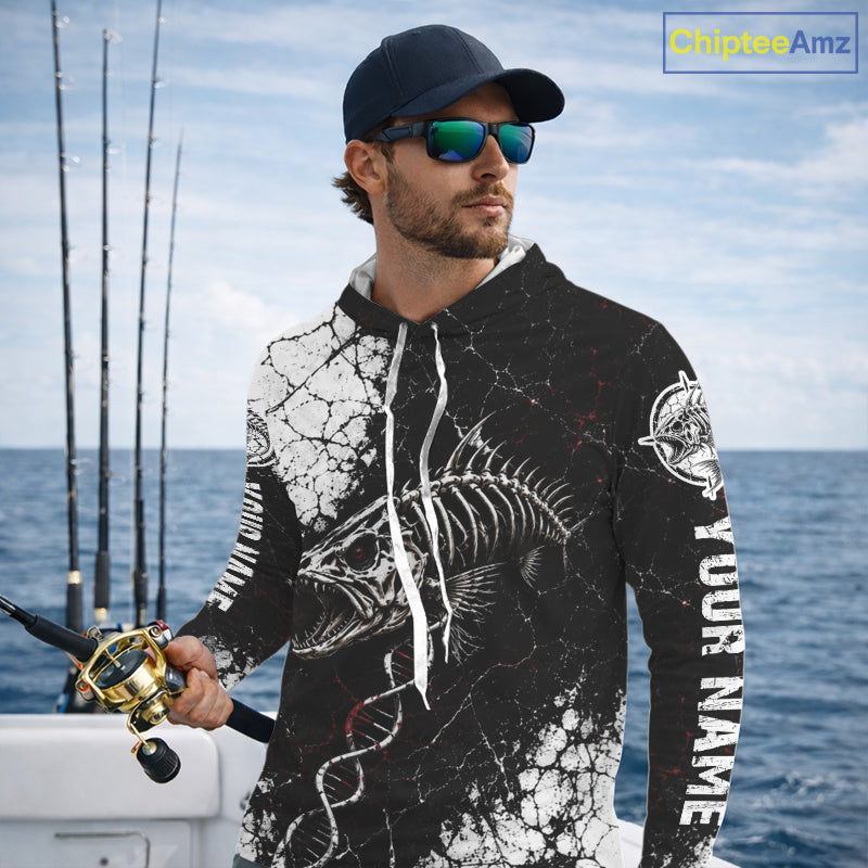 Man on a boat wearing a black and white long-sleeve shirt with 'Skeleton Fish' design, looking out at the ocean.