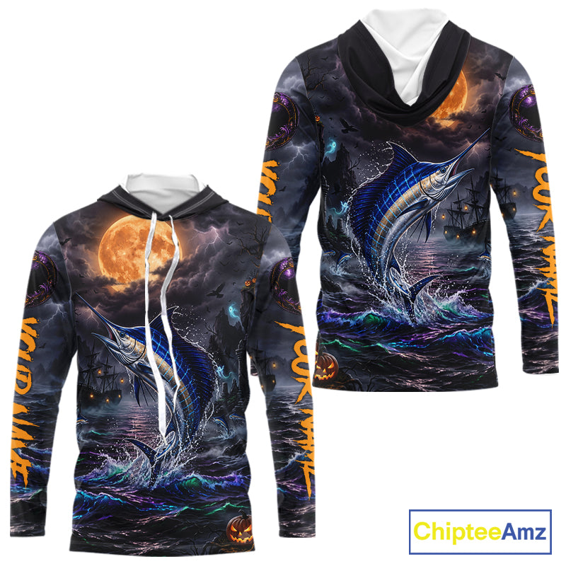 A long-sleeve hooded sweatshirt shown from the front and back, featuring an all-over Halloween-themed graphic print with a blue marlin, stormy dark water, orange full moon, jack-o'-lanterns, and orange vertical text. The hoodie has a black hood with white drawstrings and a white inner collar.