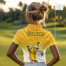 Load image into Gallery viewer, Person wearing a yellow and white golf shirt with a cartoon banana character on a golf course.