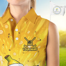 Load image into Gallery viewer, Yellow sleeveless shirt with banana pattern and golf club design, featuring a customizable name area, on a blurred outdoor background.