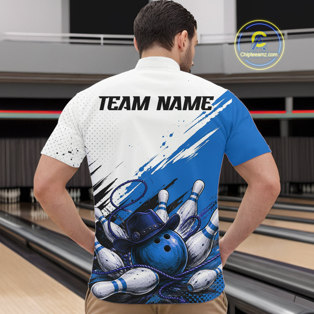 A man viewed from behind wearing a custom bowling-themed short-sleeve shirt with 'TEAM NAME' printed on the back, set against a bowling alley background.