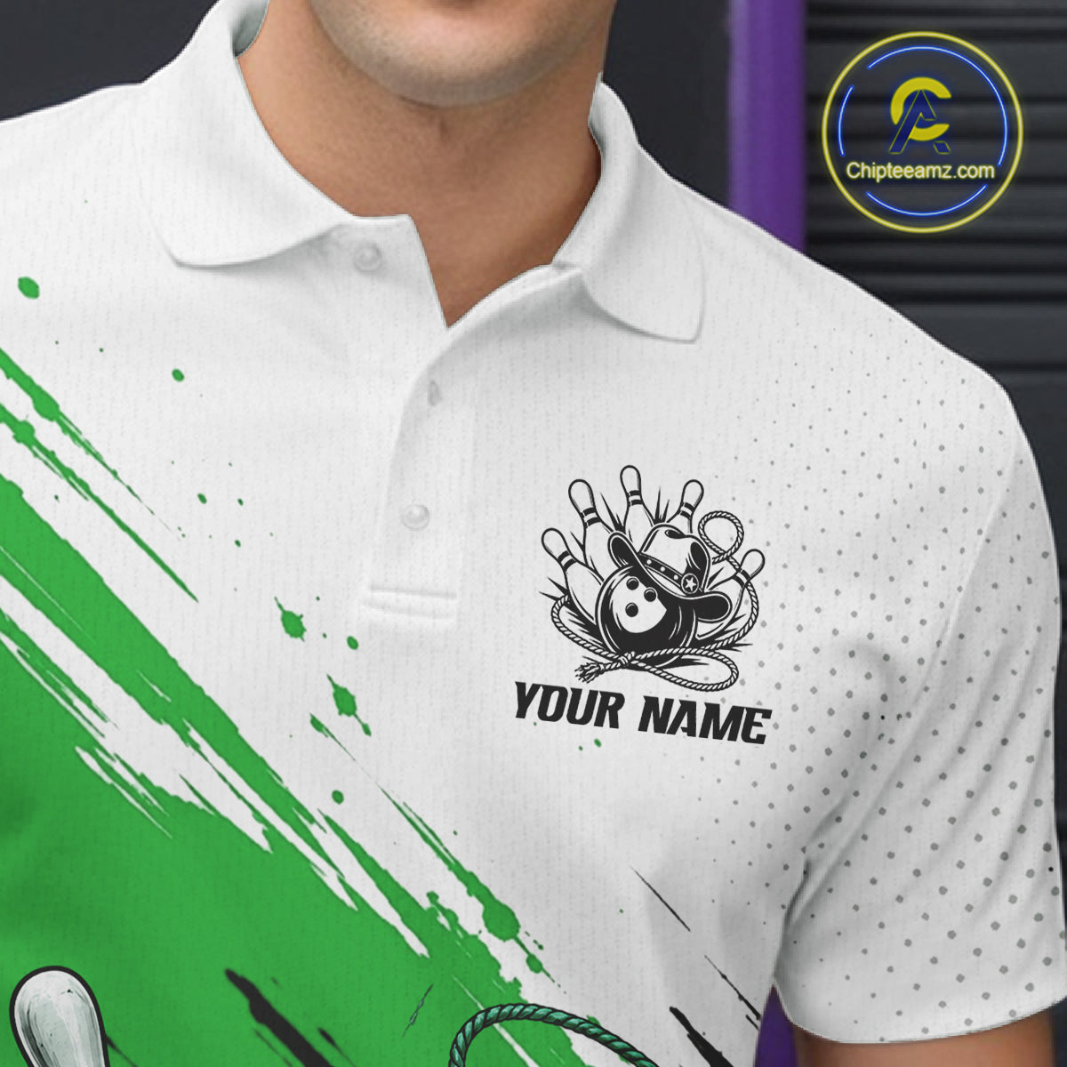 White polo shirt with a black bowling-themed chest graphic and the text 'YOUR NAME', shown on a cropped model torso. A green paint-splatter design appears across the lower left