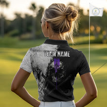 Load image into Gallery viewer, Person wearing a black polo shirt with a skull design and 'Team Name' text on a golf course.