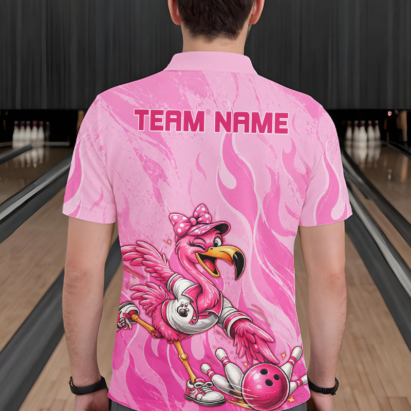 A person viewed from behind wearing a pink short-sleeve bowling shirt with a flamingo graphic and the text 'TEAM NAME' on the back, standing in a bowling alley.