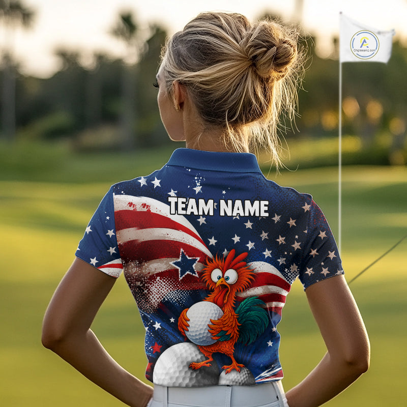 A woman on a golf course seen from behind, wearing a short-sleeve polo shirt with a patriotic American flag design, white stars, a blue rooster holding golf balls, and the text 'TEAM NAME' printed across the upper back.