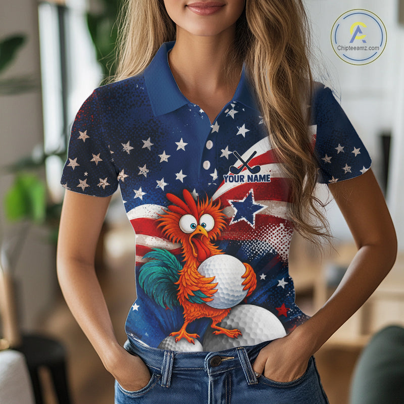 A woman wearing a short-sleeve polo shirt with a patriotic American flag design featuring white stars on a blue background, red and white stripes, and a cartoon rooster holding a golf ball. The shirt has a customizable text placeholder 'YOUR NAME' on the chest.