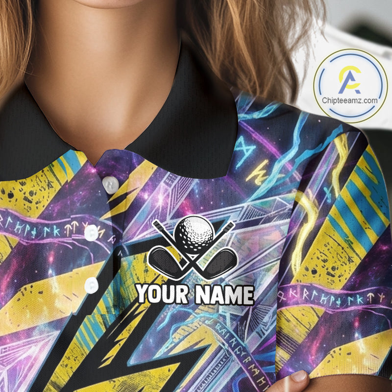 Close-up of a person wearing a short-sleeve polo shirt with a black collar and a vivid all-over graphic print in purple, blue, yellow, and black. The shirt has a golf-themed chest graphic with a golf ball, crossed clubs, and the text 'YOUR NAME,' indicating personalization.