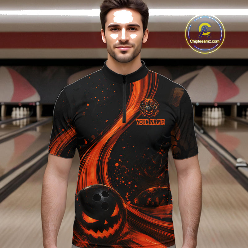 A man wearing a black short-sleeve bowling jersey with a Halloween-themed orange and black graphic print, standing in a bowling alley. The jersey features a pumpkin bowling ball graphic on the front and a circular 'Chipteeamz"
