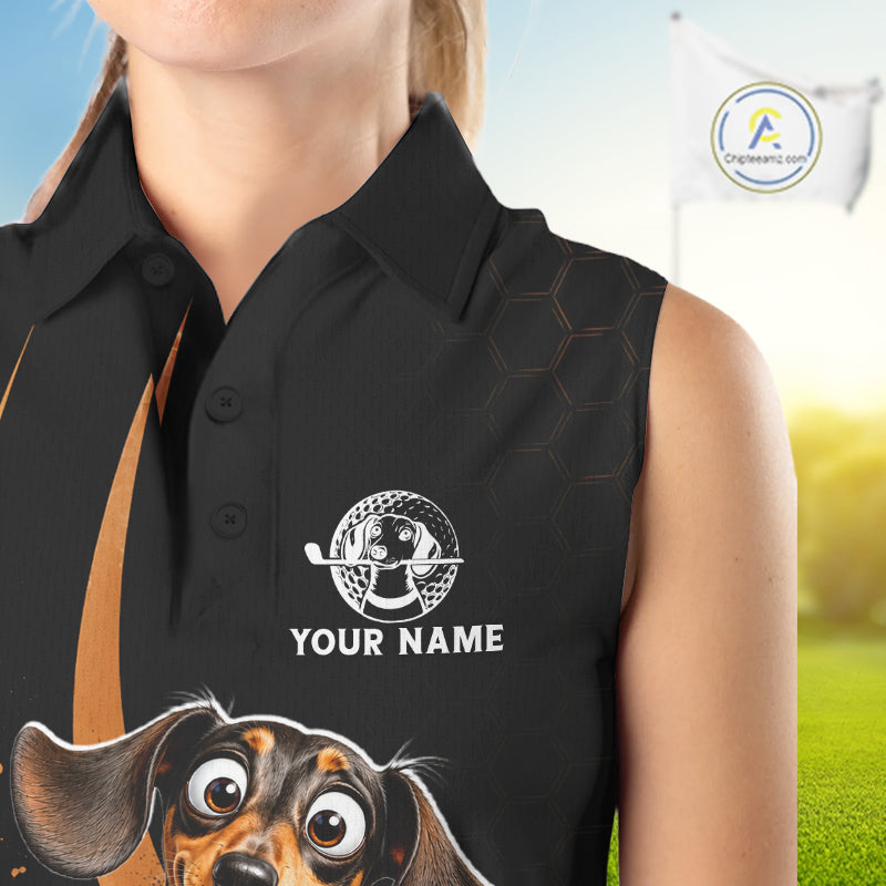 A sleeveless black polo shirt with a custom graphic of a dachshund dog and white placeholder text reading 'YOUR NAME', shown on a model against a golf course background.