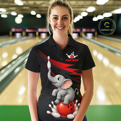 A woman wearing a black short-sleeve bowling-themed polo shirt with a cartoon elephant and red bowling ball graphic, standing in a bowling alley. The shirt has a customizable text placeholder on the chest and a circular 'Chipteeamz