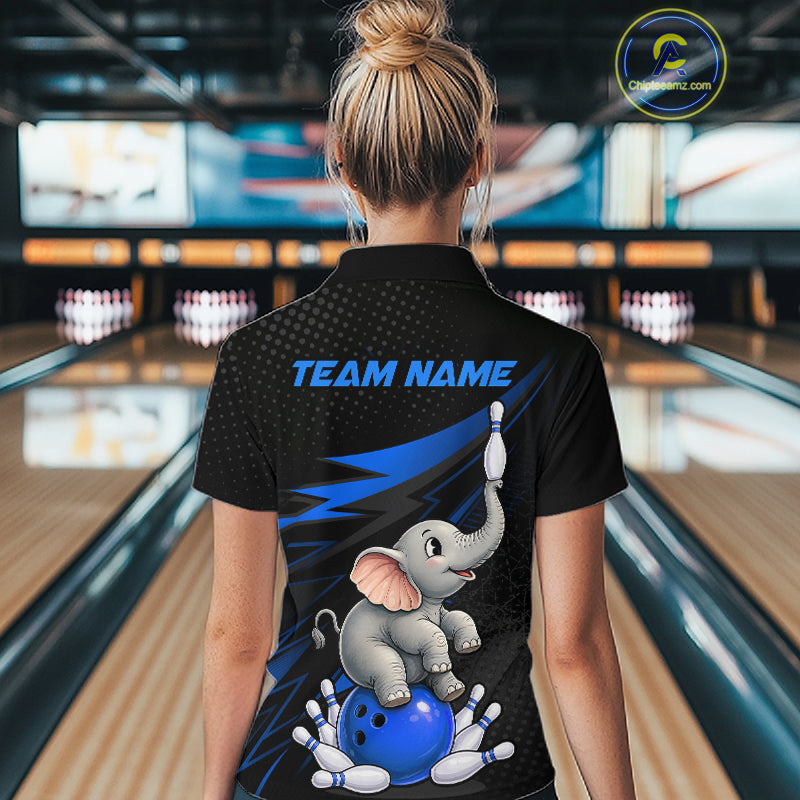 A woman viewed from behind wearing a black short-sleeve bowling-themed polo shirt with a cartoon elephant, blue bowling ball, pins, and the text 'TEAM NAME' on the back. Bowling alley lanes are visible in the background.