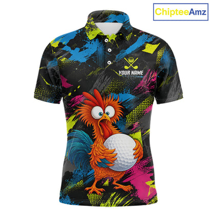 A short-sleeve polo shirt with a colorful abstract paint-splatter background in blue, pink, yellow, and green on a black base. The shirt features a cartoon rooster holding a white golf ball on the front, with a customizable name print and crossed golf clubs graphic on the left chest.