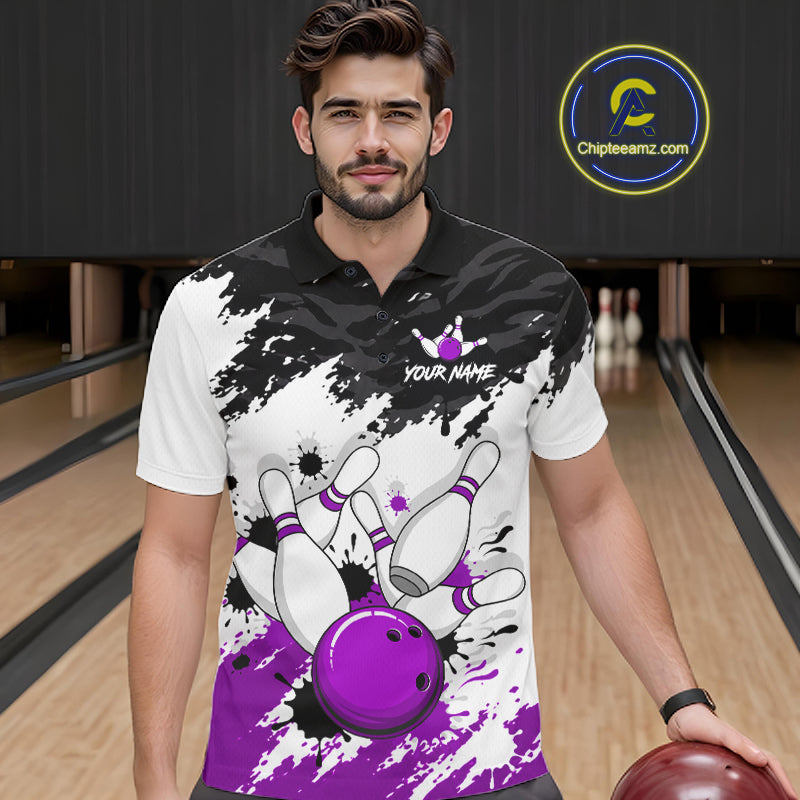 A man wearing a custom bowling-themed polo shirt with a black and white splatter design, purple bowling pins, and a purple bowling ball graphic. The background shows a bowling alley with lanes and pins.