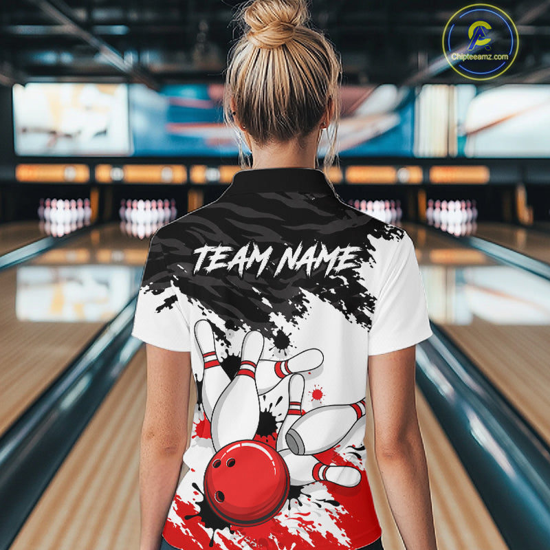 A woman viewed from behind wearing a custom bowling-themed short-sleeve polo shirt. The shirt features a white base with a black splatter design, a graphic of white bowling pins and a red bowling ball, and the text 'TEAM NAME' printed across the upper back.