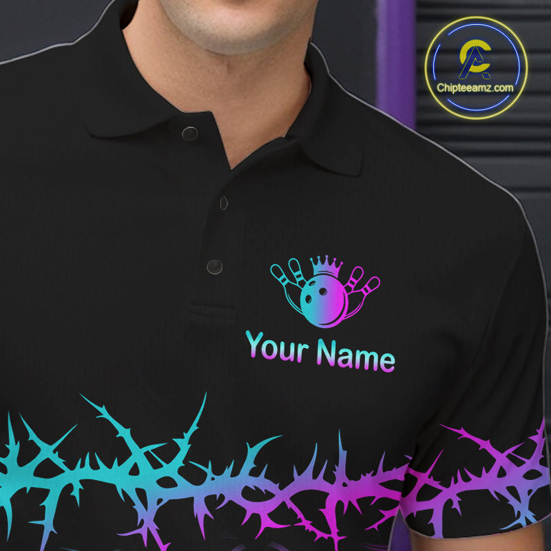 A close-up of a black polo shirt worn by a model, featuring a bowling-themed graphic with a crown, pins, and the text 'Your Name' in a neon blue-to-purple gradient. A matching gradient thorny pattern runs along the bottom hem.