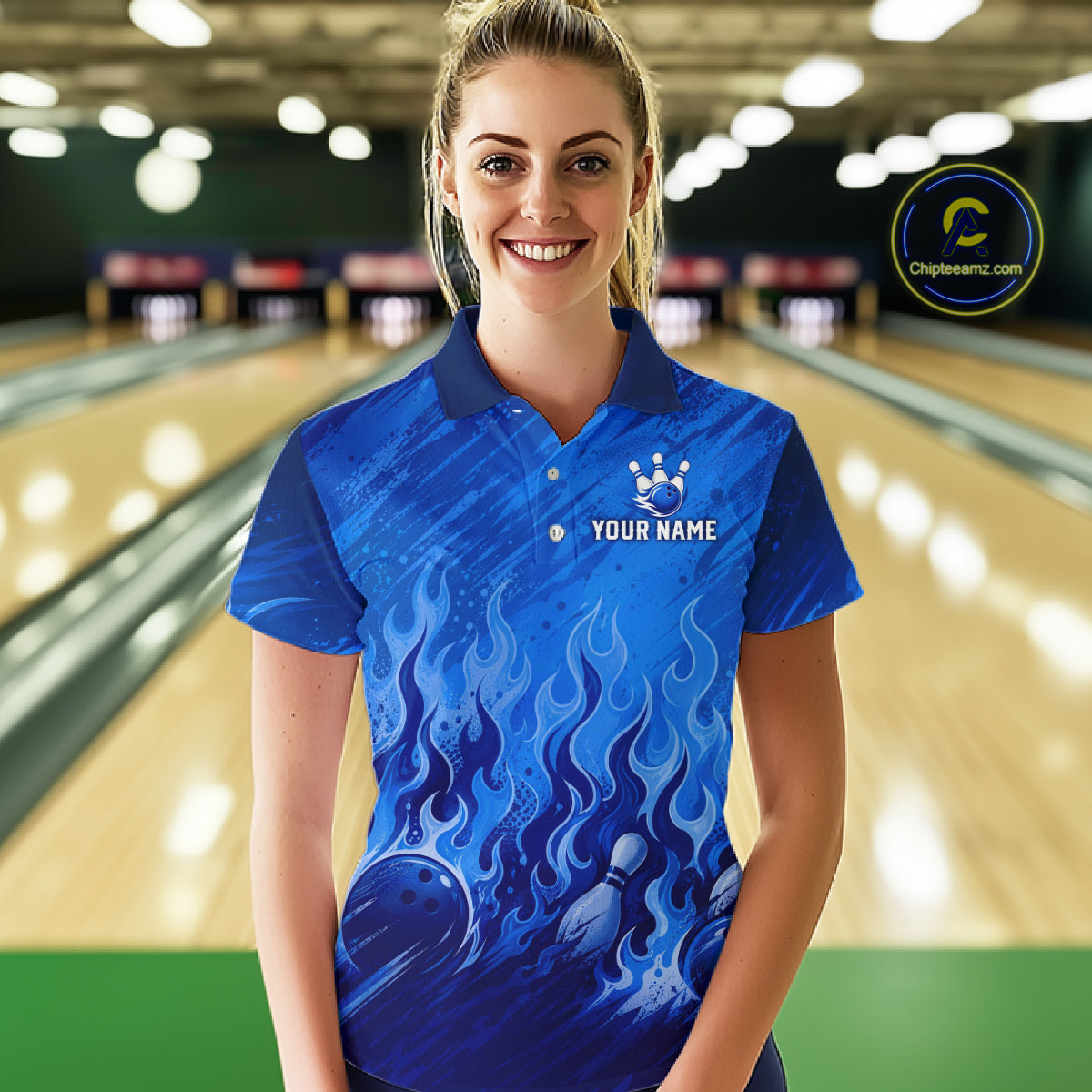 A woman stands in a bowling alley wearing a blue short-sleeve polo shirt with a flame and bowling ball graphic, featuring a white bowling pins logo and customizable text on the chest. A circular 'Chipteewanz' watermark is visible in the top right corner.