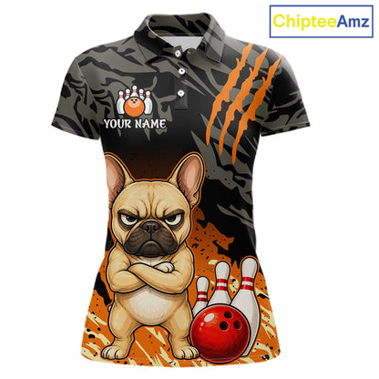A women's short-sleeve polo shirt with a black and gray camouflage pattern, orange claw-stripe graphics, and a cartoon French bulldog bowling design. The shirt includes a customizable name graphic and a red bowling ball.