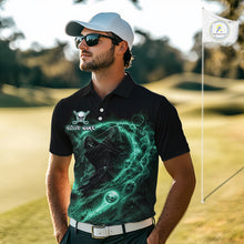 Load image into Gallery viewer, Man wearing a black golf shirt with a green graphic design on a golf course