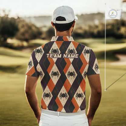 A man viewed from behind on a golf course, wearing a short-sleeve collared polo shirt with an orange, cream, and dark gray argyle pattern featuring spider graphics and the text 'TEAM NAME' across the upper back. He is also wearing a white cap and white pants.