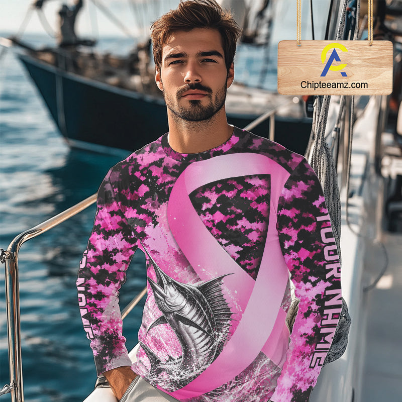 Angler wearing pink ribbon camouflage marlin fishing breast cancer long sleeve sun protection shirt on the water