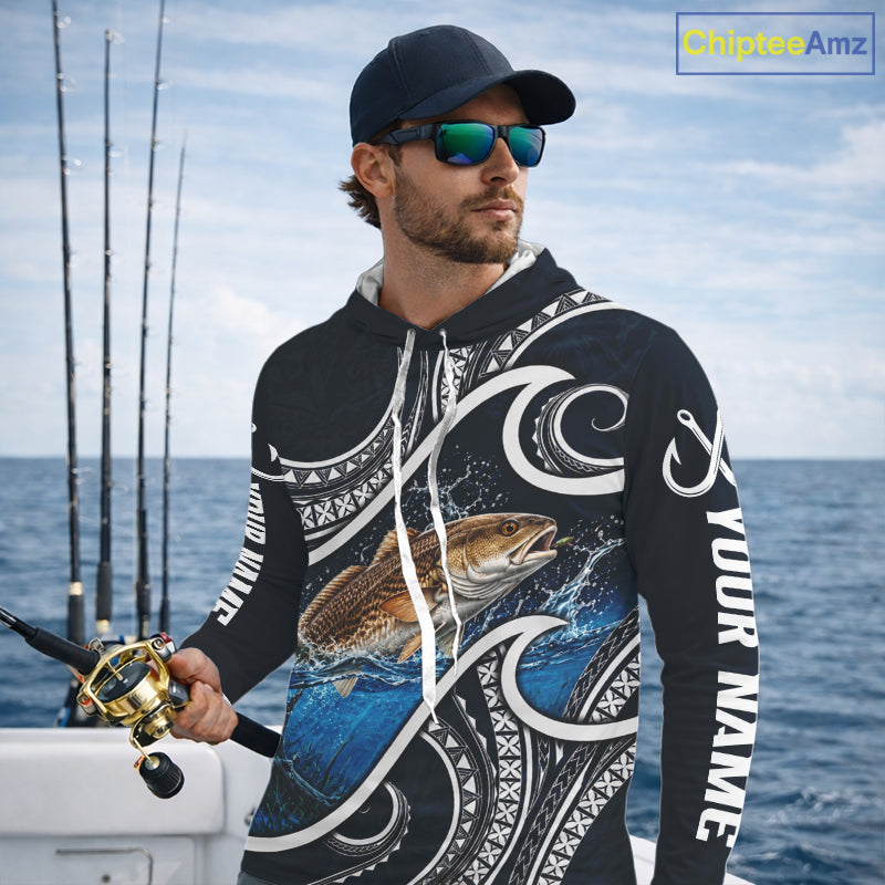 Angler wearing blue tribal pattern custom redfish long sleeve hooded fishing shirt on the water