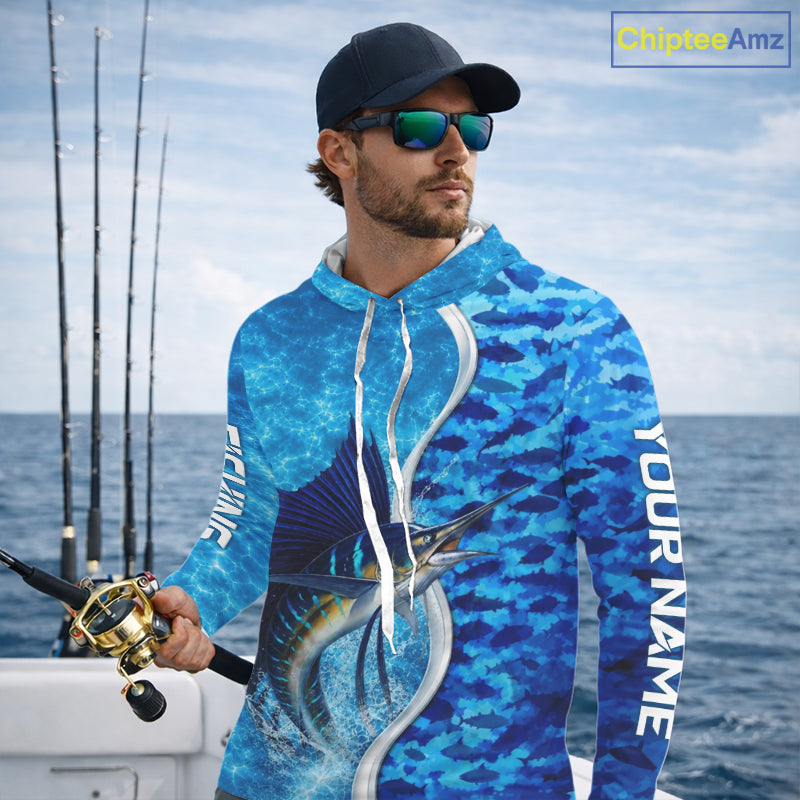 Angler wearing Sailfish fishing blue ocean camouflage performance long sleeve hooded fishing shirt on the water