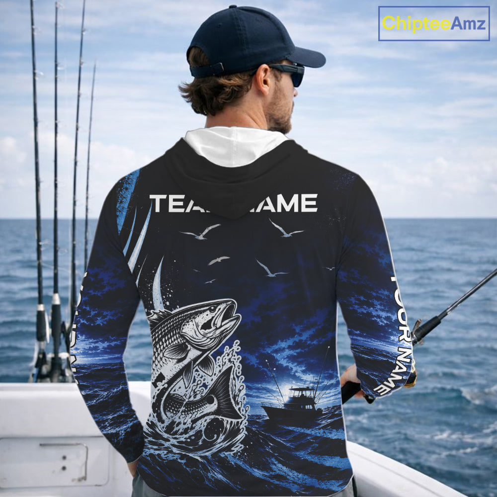 Angler wearing personalized Redfish Red Drum blue long sleeve hooded performance fishing shirt on the water - back view