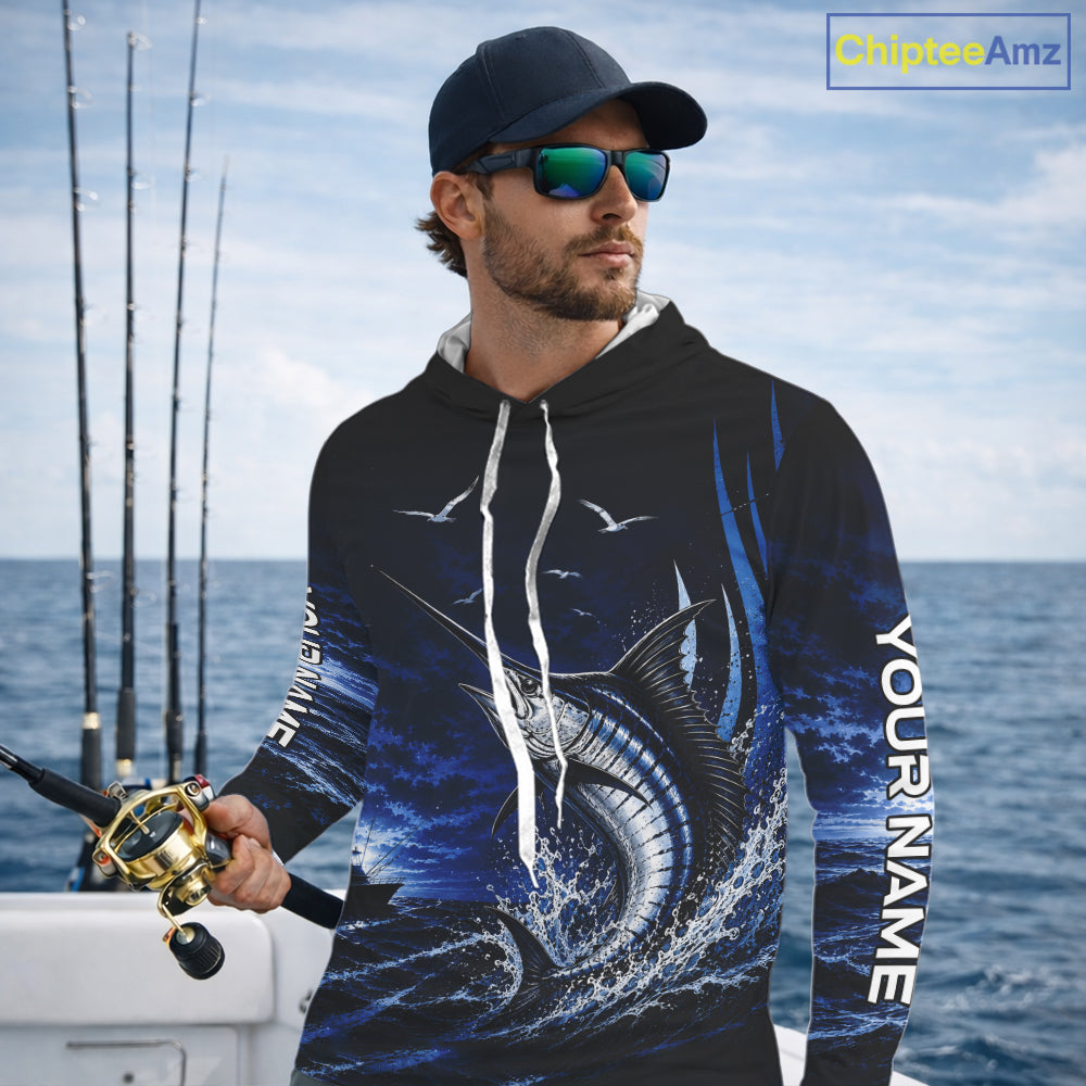 Angler wearing personalized Blue Marlin blue long sleeve hooded performance fishing shirt on the water