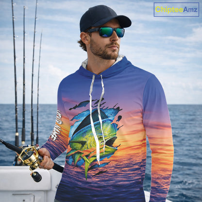 Angler wearing Mahi Mahi Fishing Sunset custom long sleeve hooded mahi mshi offshore fishing shirt on the boat at sunset