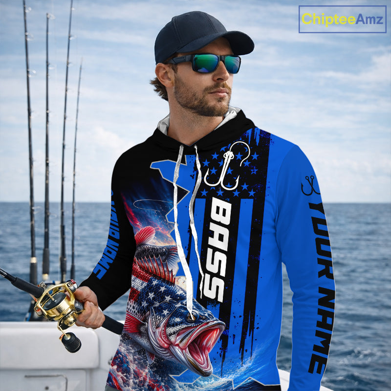Angler wearing custom American flag bass patriotic blue camo long sleeve hooded fishing shirt on the water