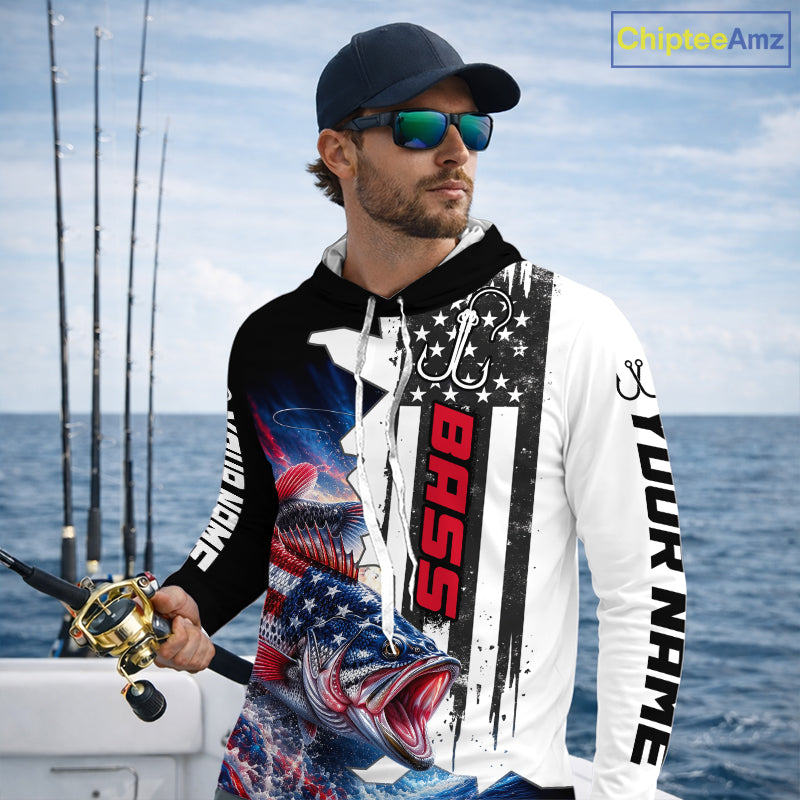 Angler wearing custom American flag bass patriotic black camo long sleeve hooded fishing shirt on the water 