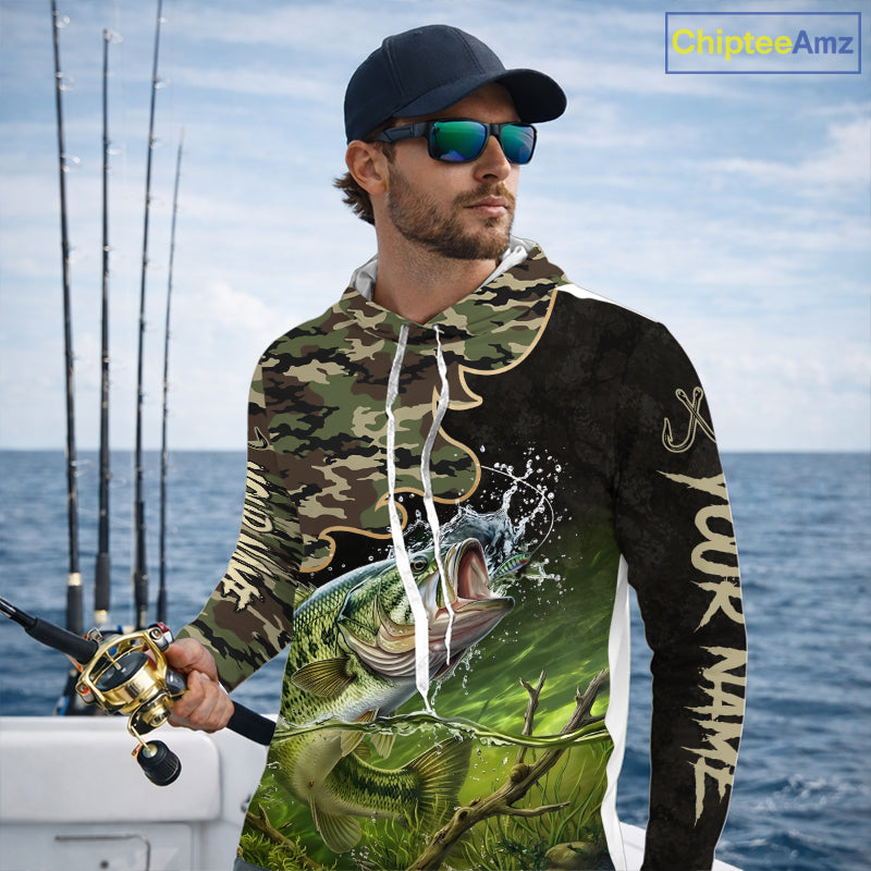 Angler wearing personalized green camouflage largemouth bass long sleeve hooded fishing shirt on the water