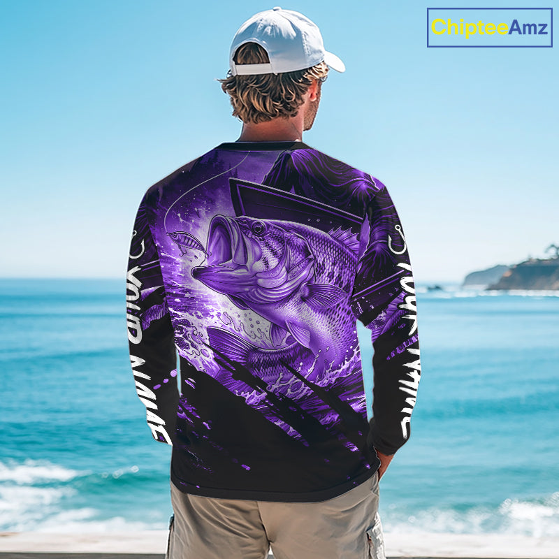 Person wearing a purple and black bass fishing shirt with a fish design, standing by the ocean.