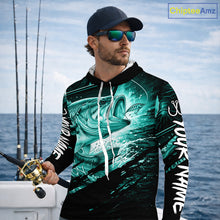 Load image into Gallery viewer, Man wearing a long sleeve hooded fishing shirt with a teal bass fish design on a boat