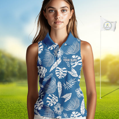 Woman wearing a blue sleeveless golf shirt with white leaf pattern on a golf course.
