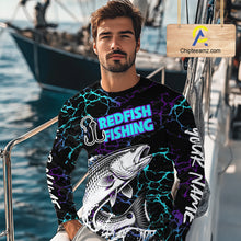 Load image into Gallery viewer, Angler wearing Redfish Fishing neon blue long sleeve saltwater fishing shirt on the boat