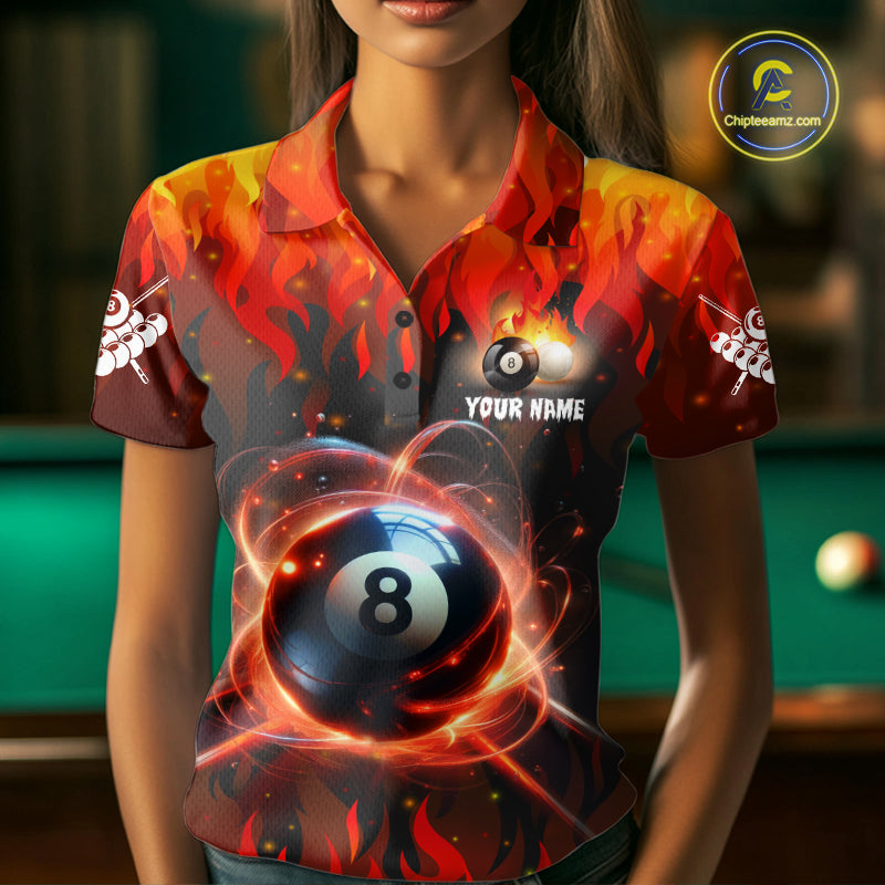 Woman wearing a red 8 ball fire flame billiard jersey beside a pool table front view.