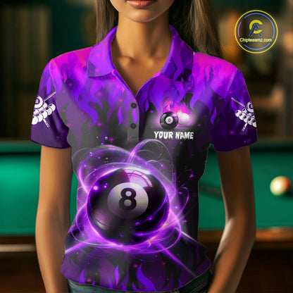 Woman wearing a purple 8 ball fire flame billiard jersey beside a pool table front view.