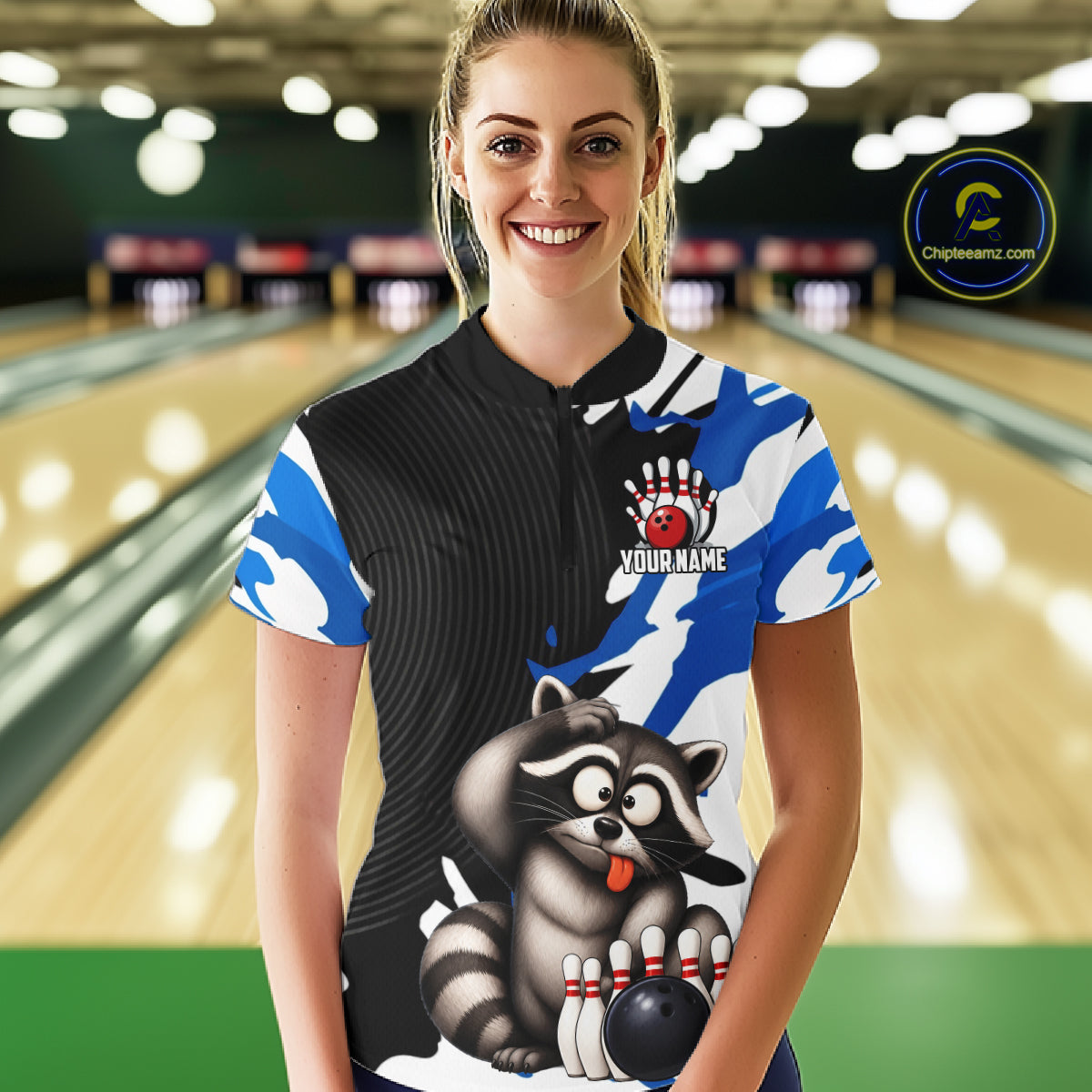 Woman wearing a bowling shirt with a raccoon design in a bowling alley.