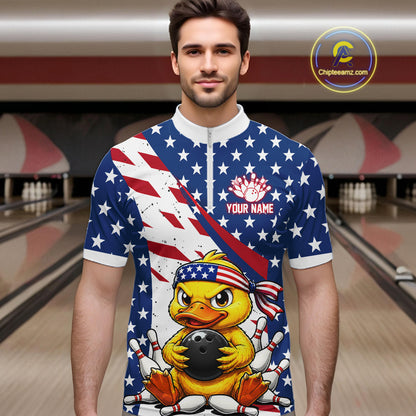 Man wearing a bowling shirt with American flag design and duck holding a bowling ball in a bowling alley.