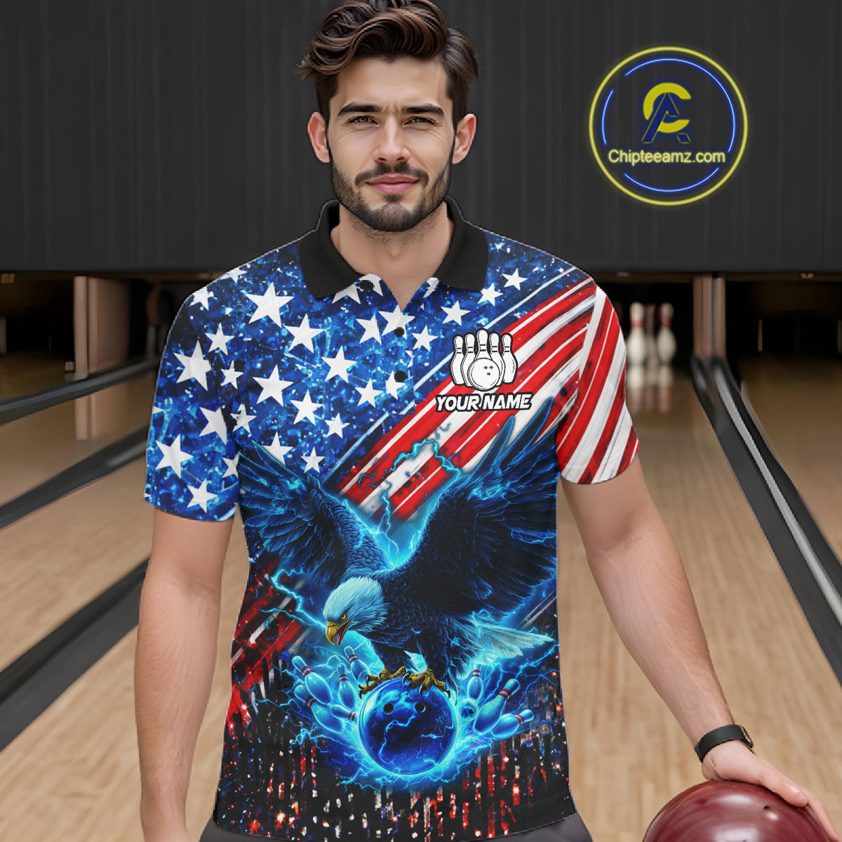 Man wearing an American flag polo shirt with an eagle design in a bowling alley, holding a bowling ball.