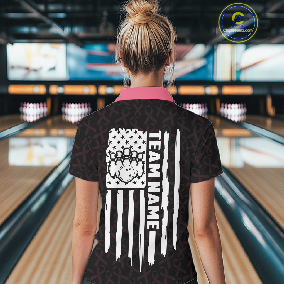 Woman wearing pink ribbon American flag bowling team jersey polo shirt featuring breast cancer awareness artwork, back view.