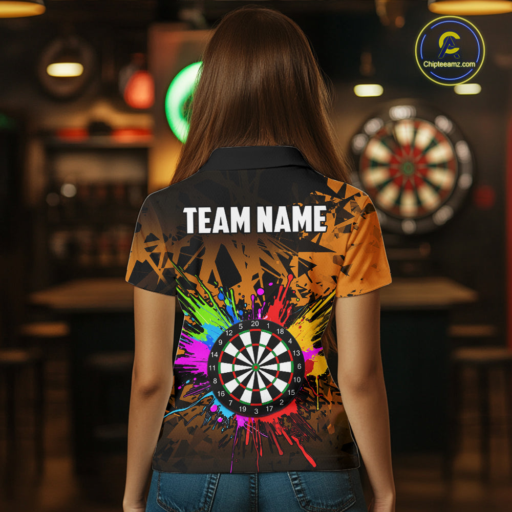 Back view of woman wearing an orange colorful darts jersey inside a darts arena.