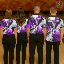 Load image into Gallery viewer, Back view of bowling team wearing matching purple splatter bowling shirts in a bowling alley.
