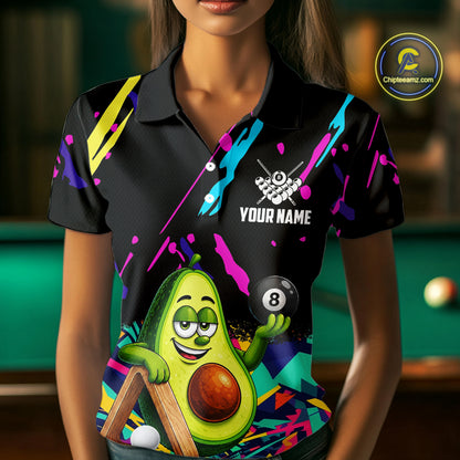 Woman wearing a colorful avocado 8 ball billiard jersey beside a pool table front view.