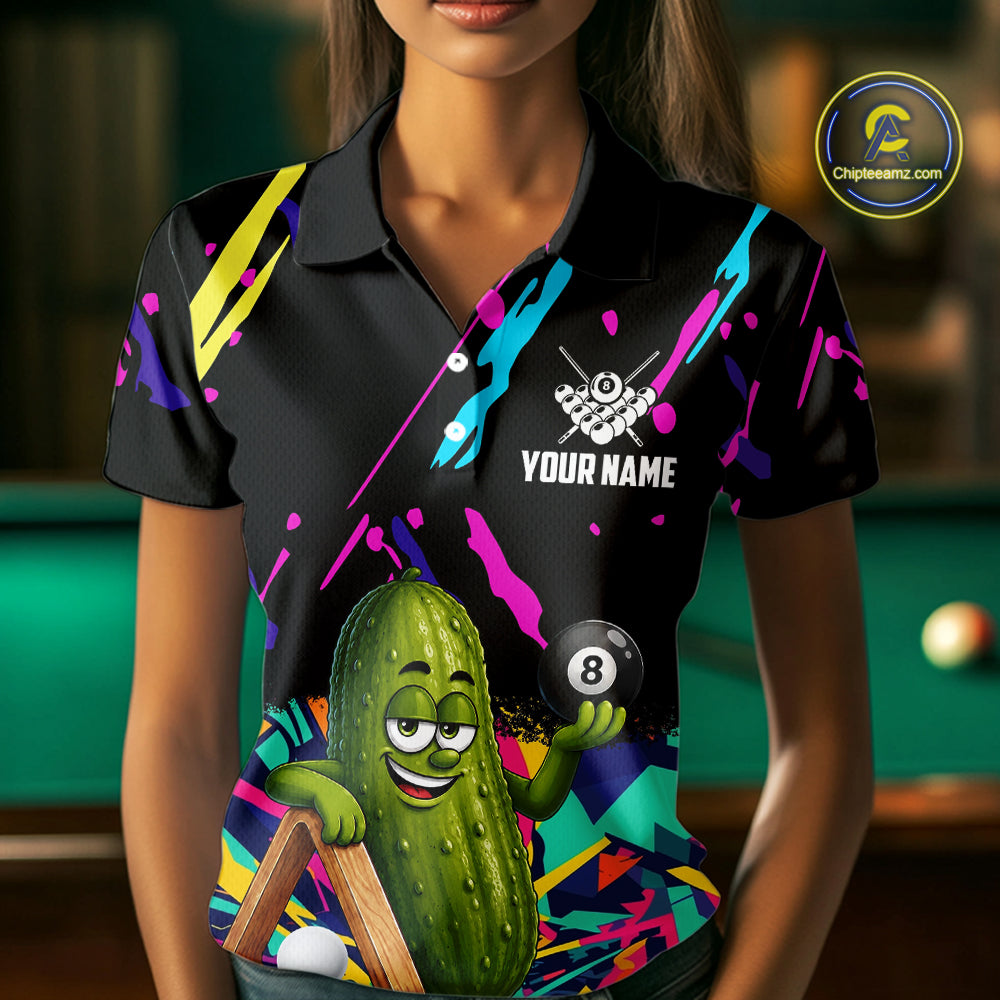 Woman wearing a colorful pickle 8 ball billiard jersey beside a pool table front view.
