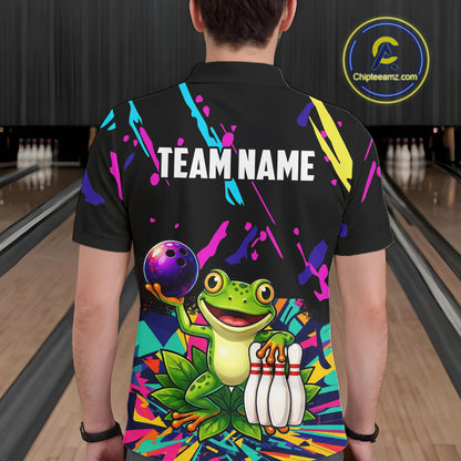 Person wearing a black bowling shirt with colorful design and frog graphic in a bowling alley.